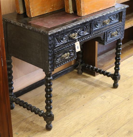 A late Victorian carved oak writing table W.90cm